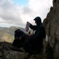 A soggy lunch atop Grooved Arete, Tryfan (Colin Maddison)