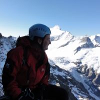 Colin concentrates hard on belaying, not at all distracted by the view (Andy Stratford)