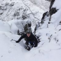 James Barrington bridges out of the entry chimney on Bristly Ridge (II.3) (Andy Stratford)