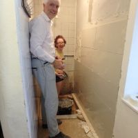 Dave W & Emily happily tiling the ladies' shower (Dave Shotton)