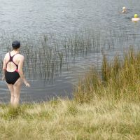 Christine contemplating the 13 degree water at Tarn at Leaves (Virginia Castick)