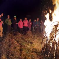Nine girls and three Daves enjoying the bonfire. (David Rainsbury)