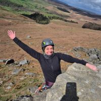 Claire Hawkins topping out on Flying Buttress